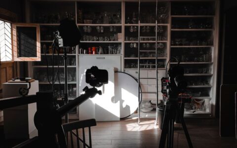 Interior view of a photography studio with cameras, lights, and equipment setup for a shoot.