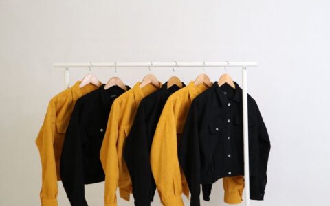 Stylish yellow and black jackets on display, perfect for fashion photography and minimalistic themes.