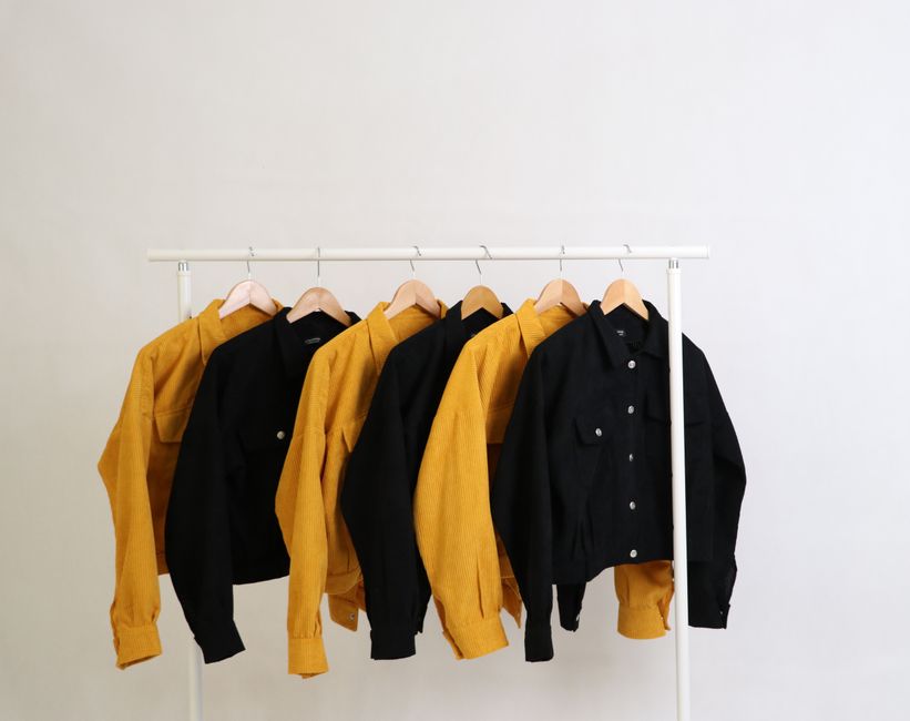 Stylish yellow and black jackets on display, perfect for fashion photography and minimalistic themes.