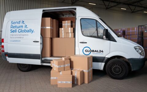 Delivery van loaded with cardboard boxes for global shipping logistics.