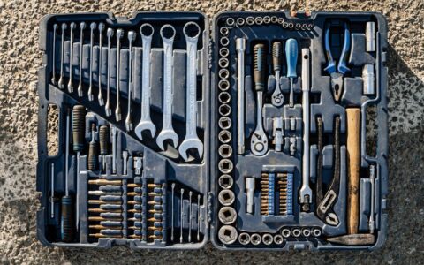 Flat lay of an organized toolbox with a variety of essential hand tools.