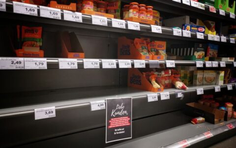 Half empty shelves with assorted products in jars and containers in supermarket during quarantine